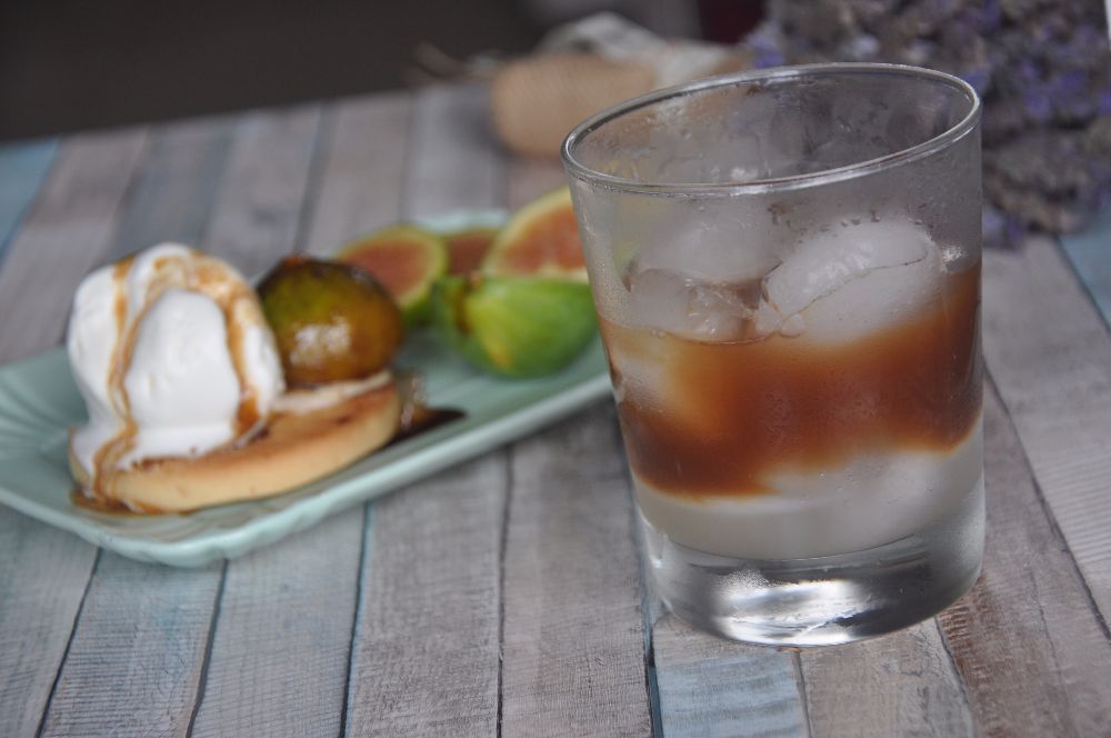 Caffè in ghiaccio con latte di mandorla e dolce